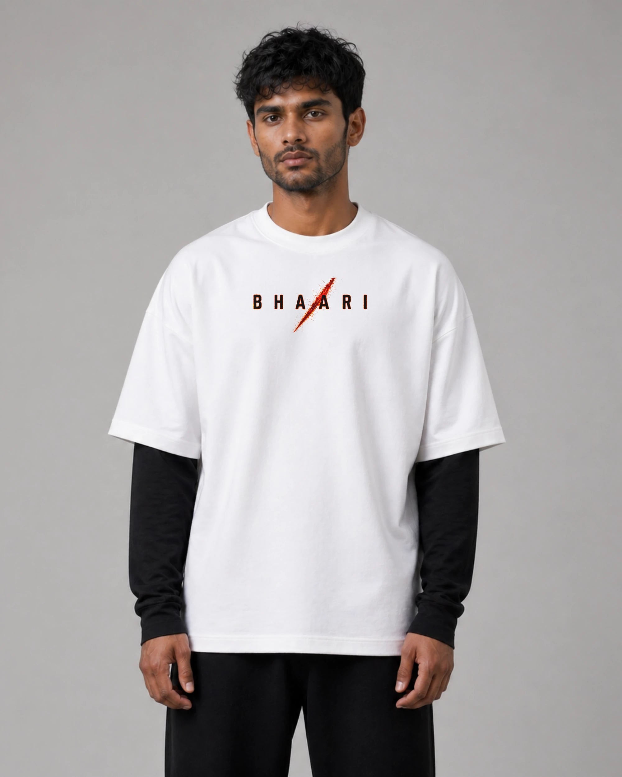 Man wearing a white t-shirt with 'BHAARI' logo on a gray background
