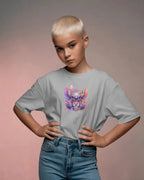 Person wearing a gray t-shirt with a colorful graphic design on a gradient background