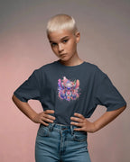 Child wearing a navy blue t-shirt with a colorful character design on a gradient background