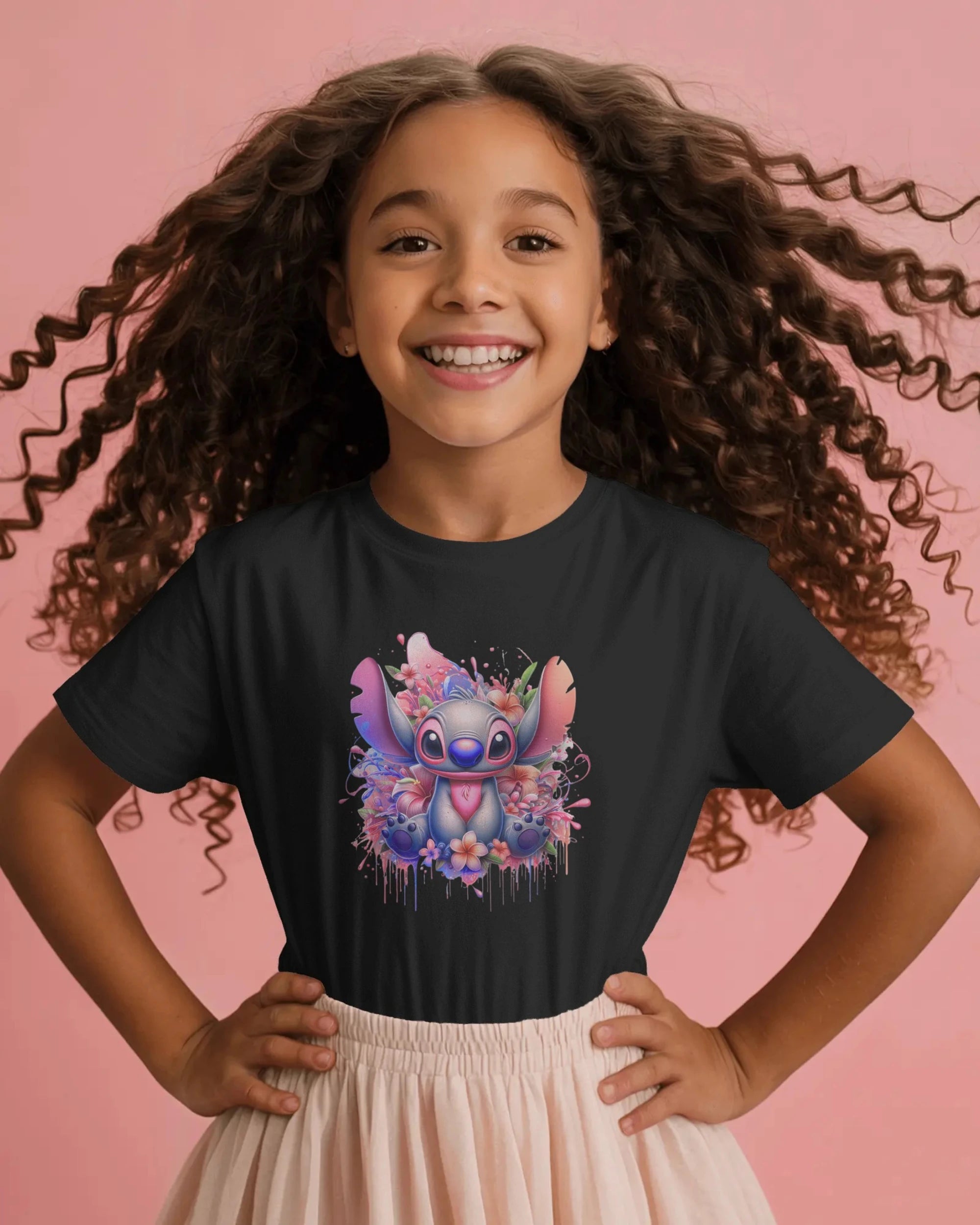 Young girl wearing a black t-shirt with a colorful character design on a pink background