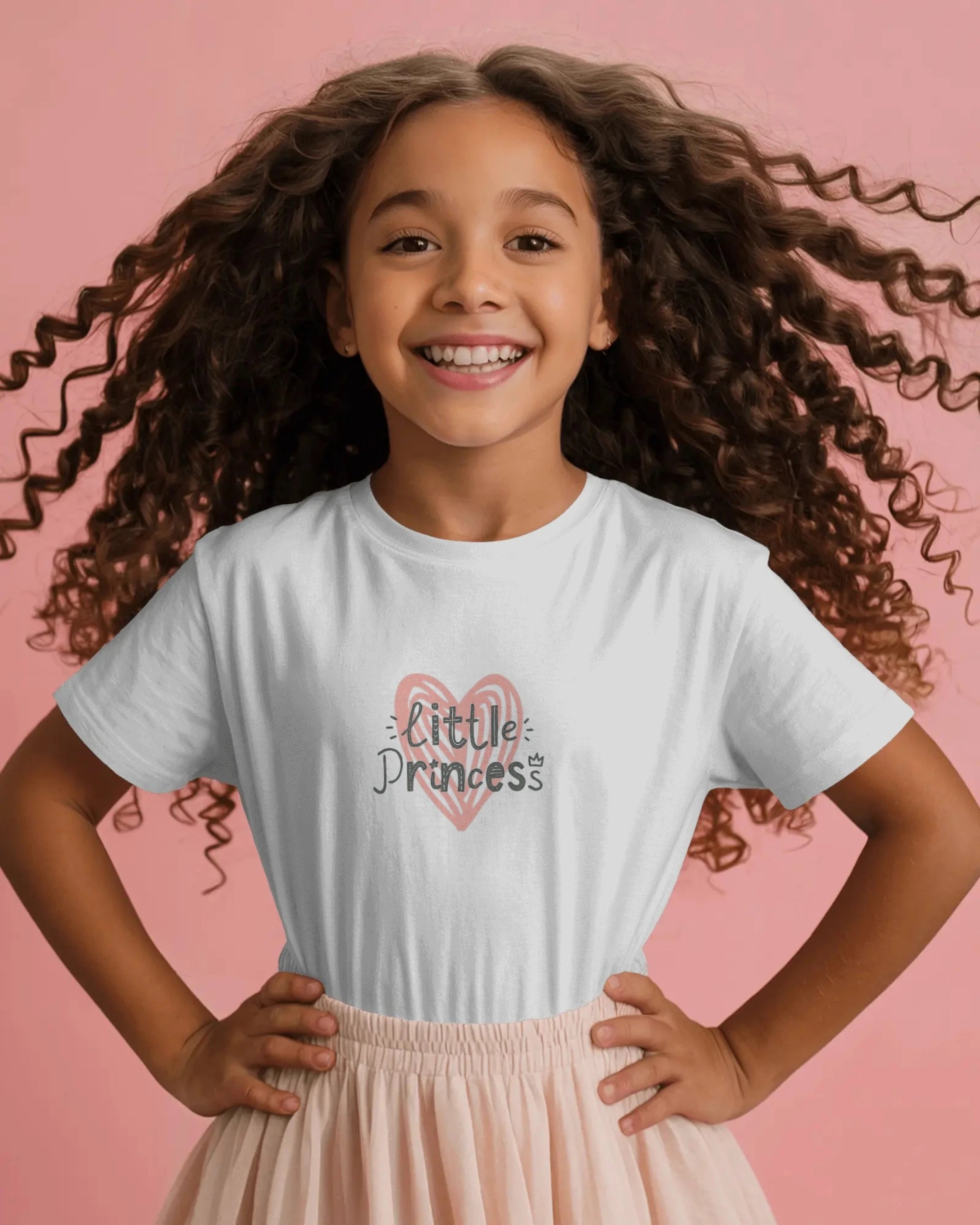 Young girl wearing a white t-shirt with a unicorn design on a pink background