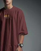 Maroon oversized T-shirt by BhaariGear featuring Honor Above All Warrior Legacy graphic on front, side view.