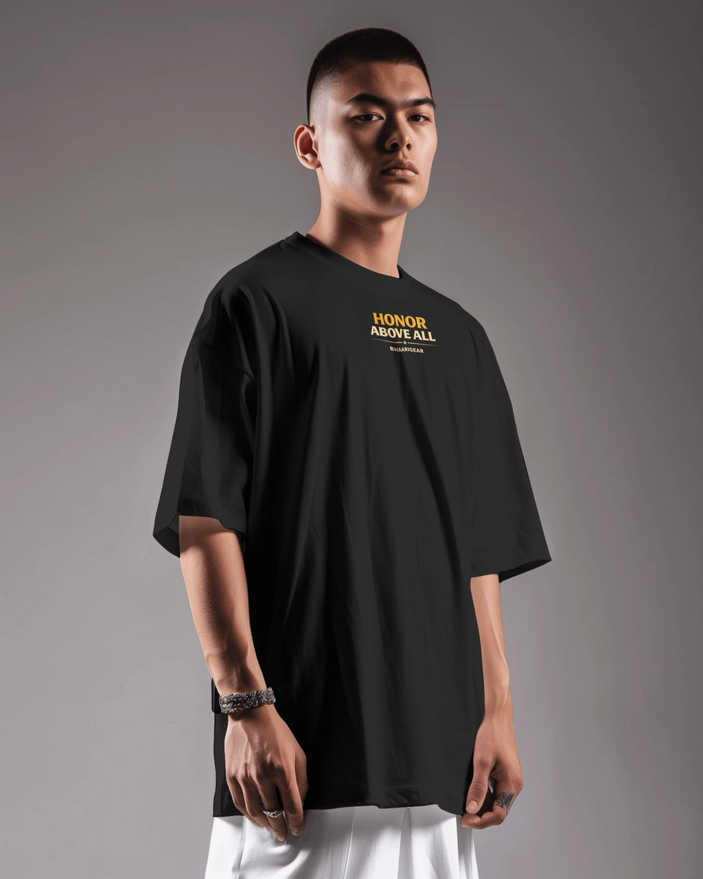 Black oversized T-shirt by BhaariGear with Honor Above All Warrior Legacy logo on front, shown from front side view.