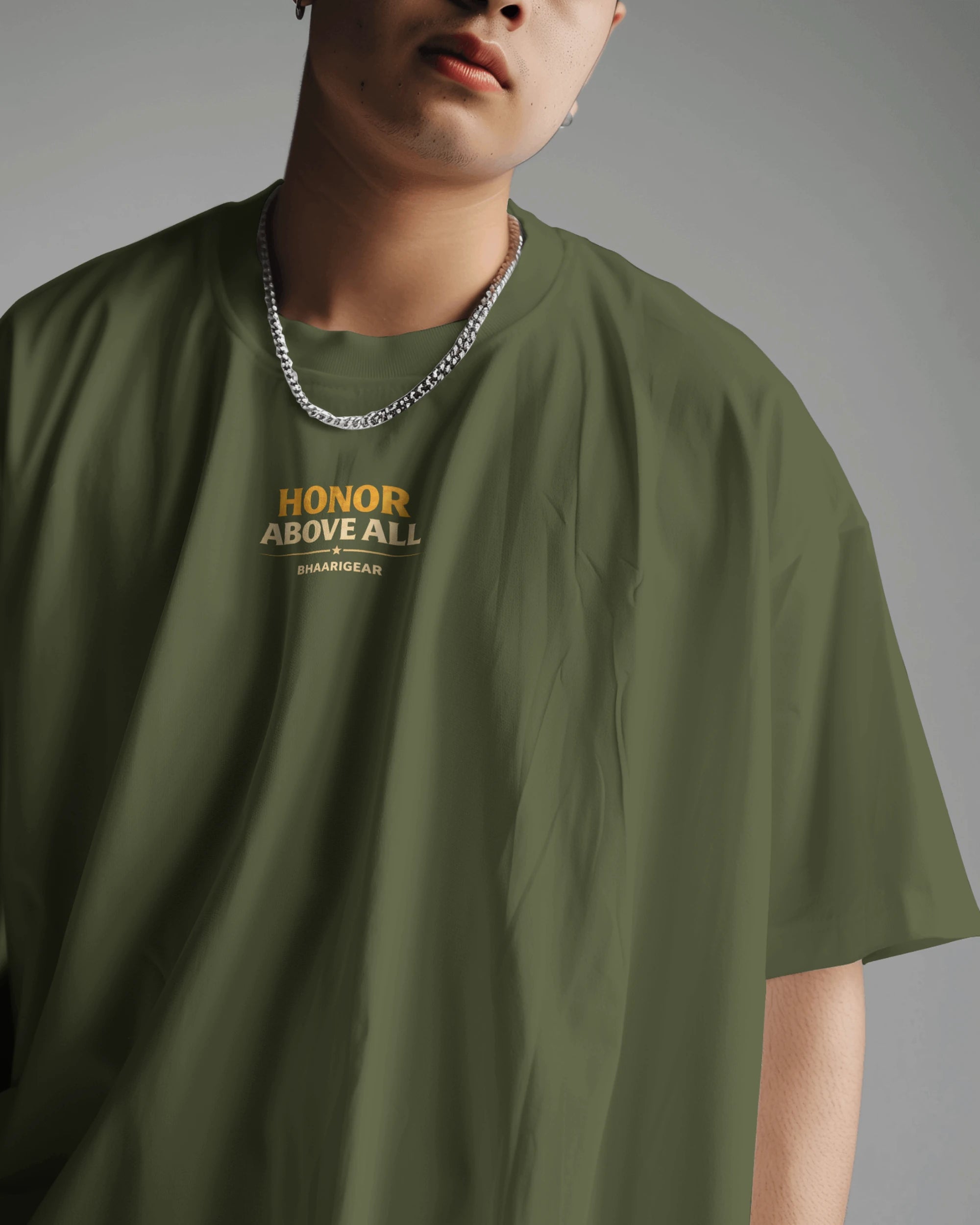 Olive green oversized T-shirt by BhaariGear with "Honor Above All Warrior" graphic front view, casual and comfortable fit.