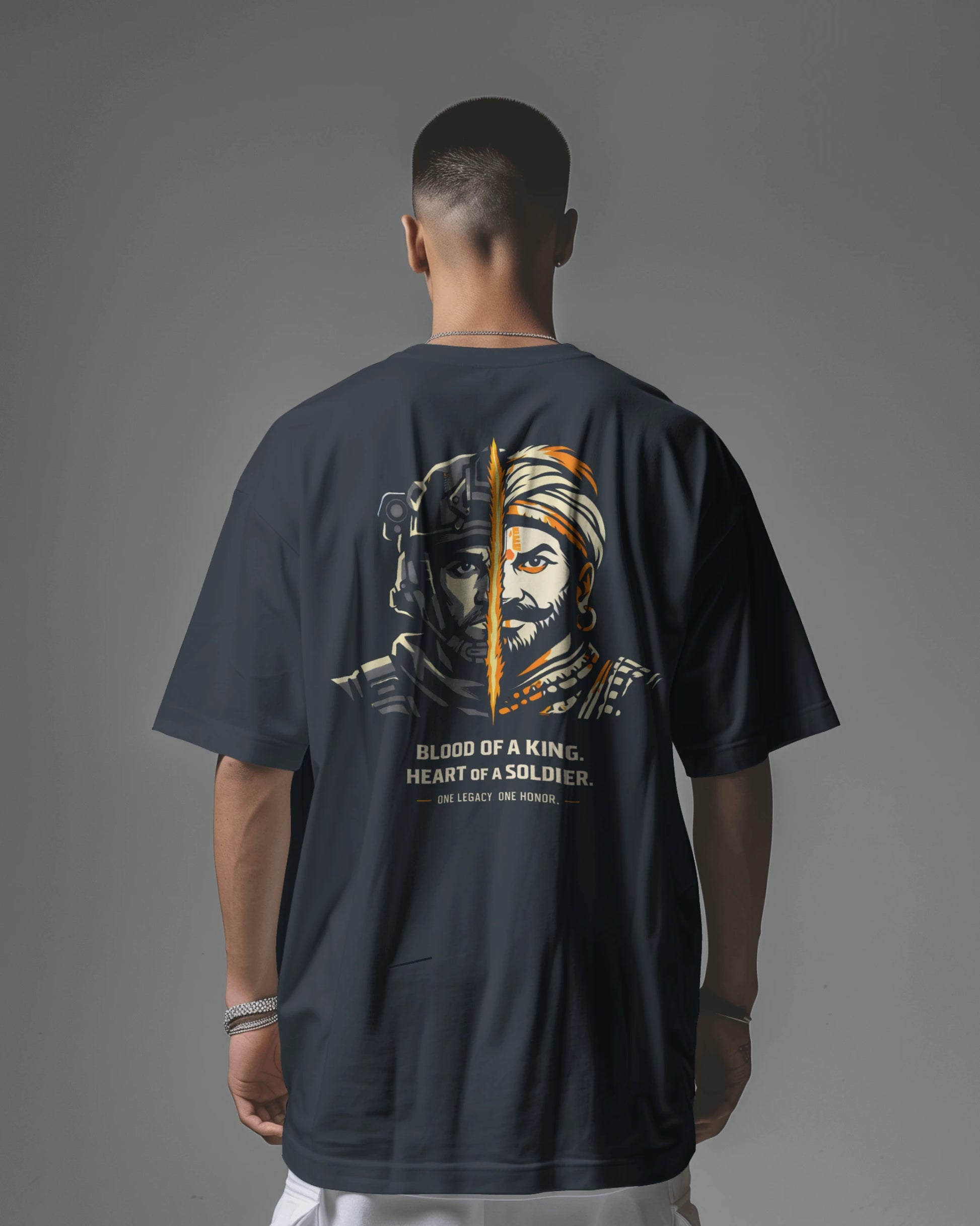Back view of navy blue Kings Blood Legacy graphic oversized T-shirt by BhaariGear featuring bold print on the front.
