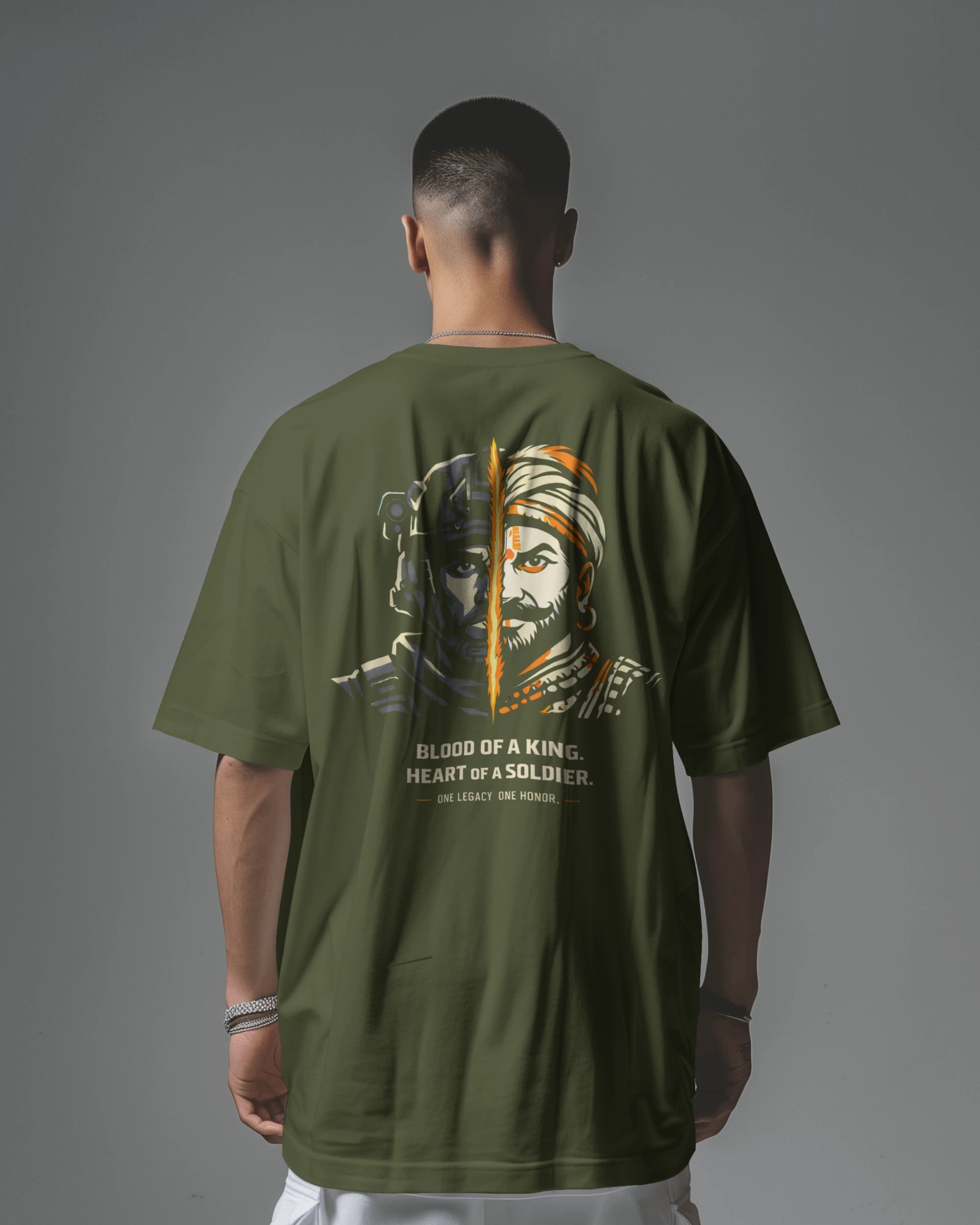 Back view of BhaariGear Kings Blood Legacy graphic oversized T-shirt in olive green, featuring bold design on the back.