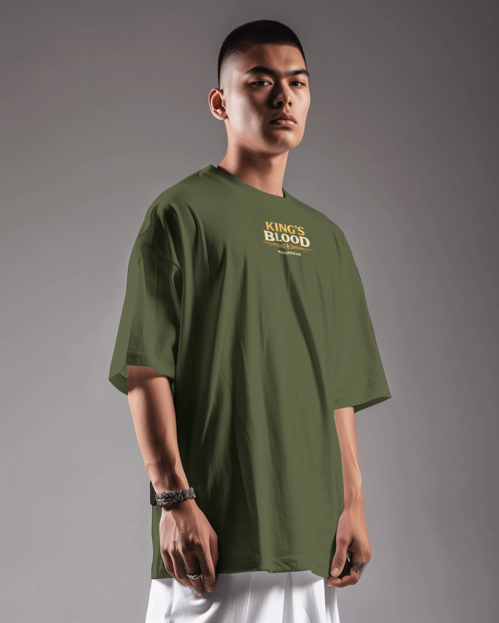 Olive green Kings Blood Legacy graphic oversized T-shirt by BhaariGear, shown from a left side view with bold design.