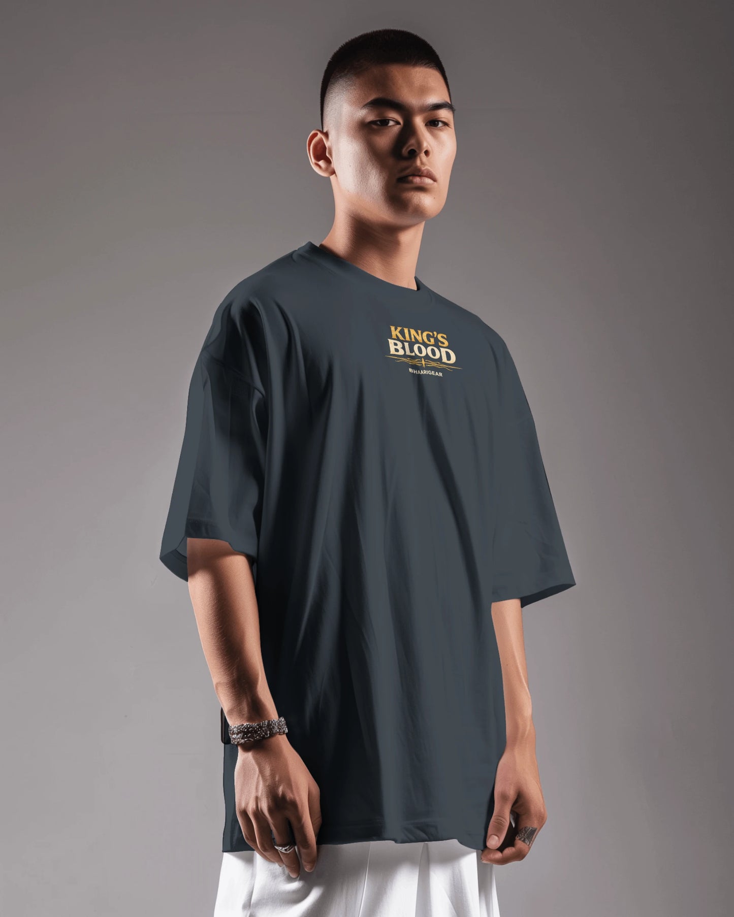 Navy blue Kings Blood Legacy graphic oversized T-shirt by BhaariGear, shown from the left side with bold print design.