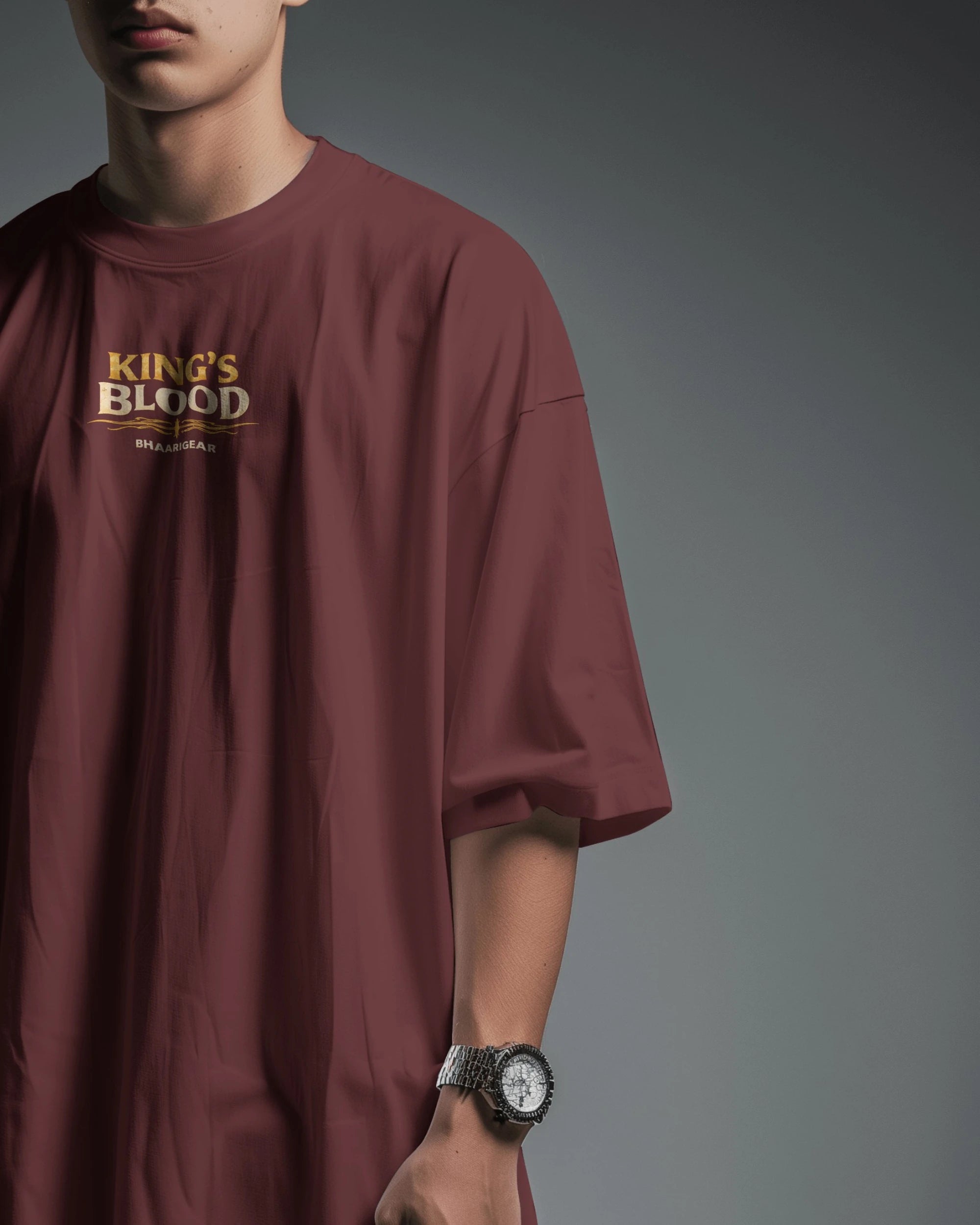 Maroon Kings Blood Legacy graphic oversized T-shirt by BhaariGear, side front view showcasing bold design and relaxed fit.