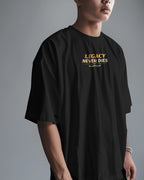 Person wearing a black t-shirt with 'Legacy Never Dies' text on a gray background