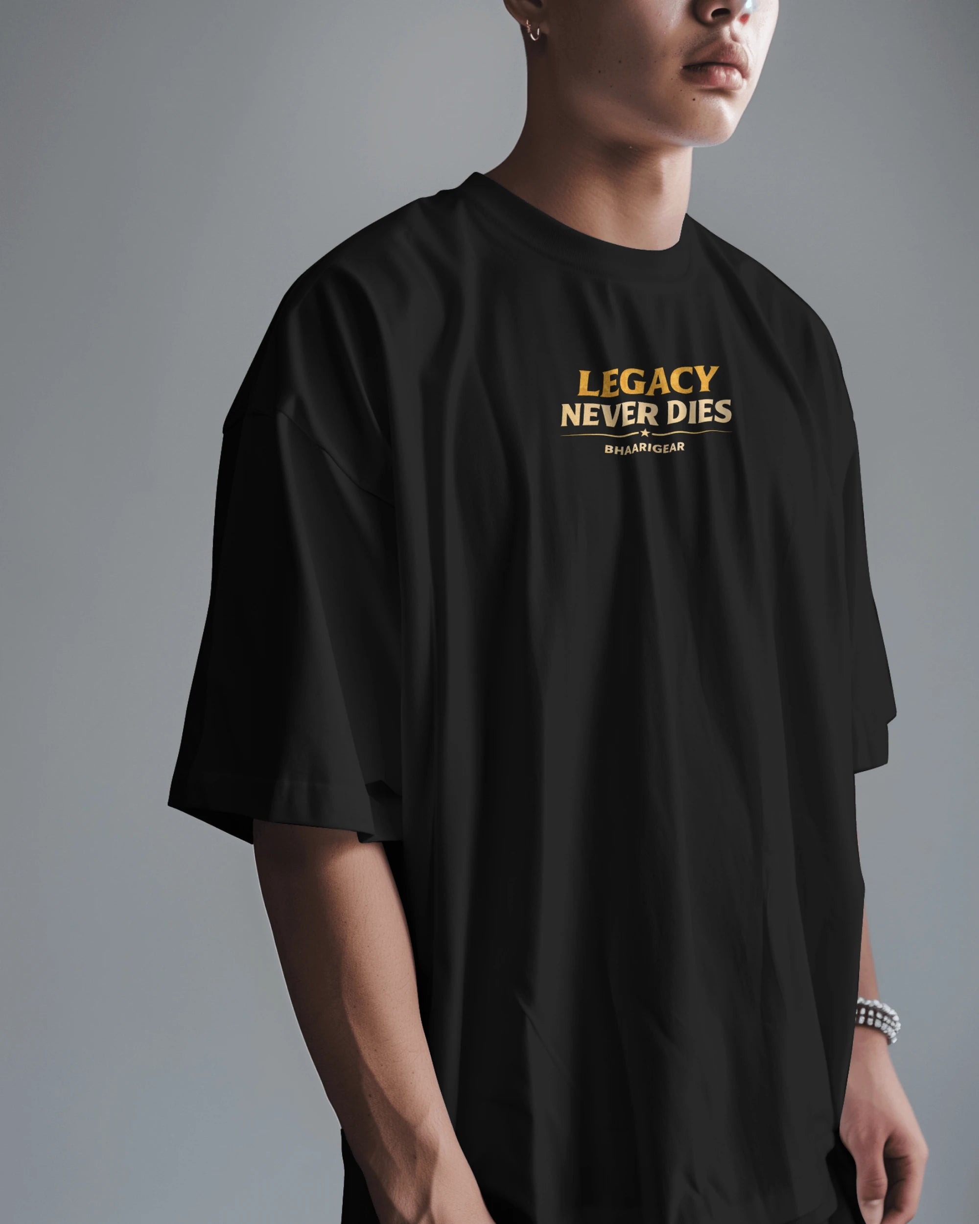 Person wearing a black t-shirt with 'Legacy Never Dies' text on a gray background