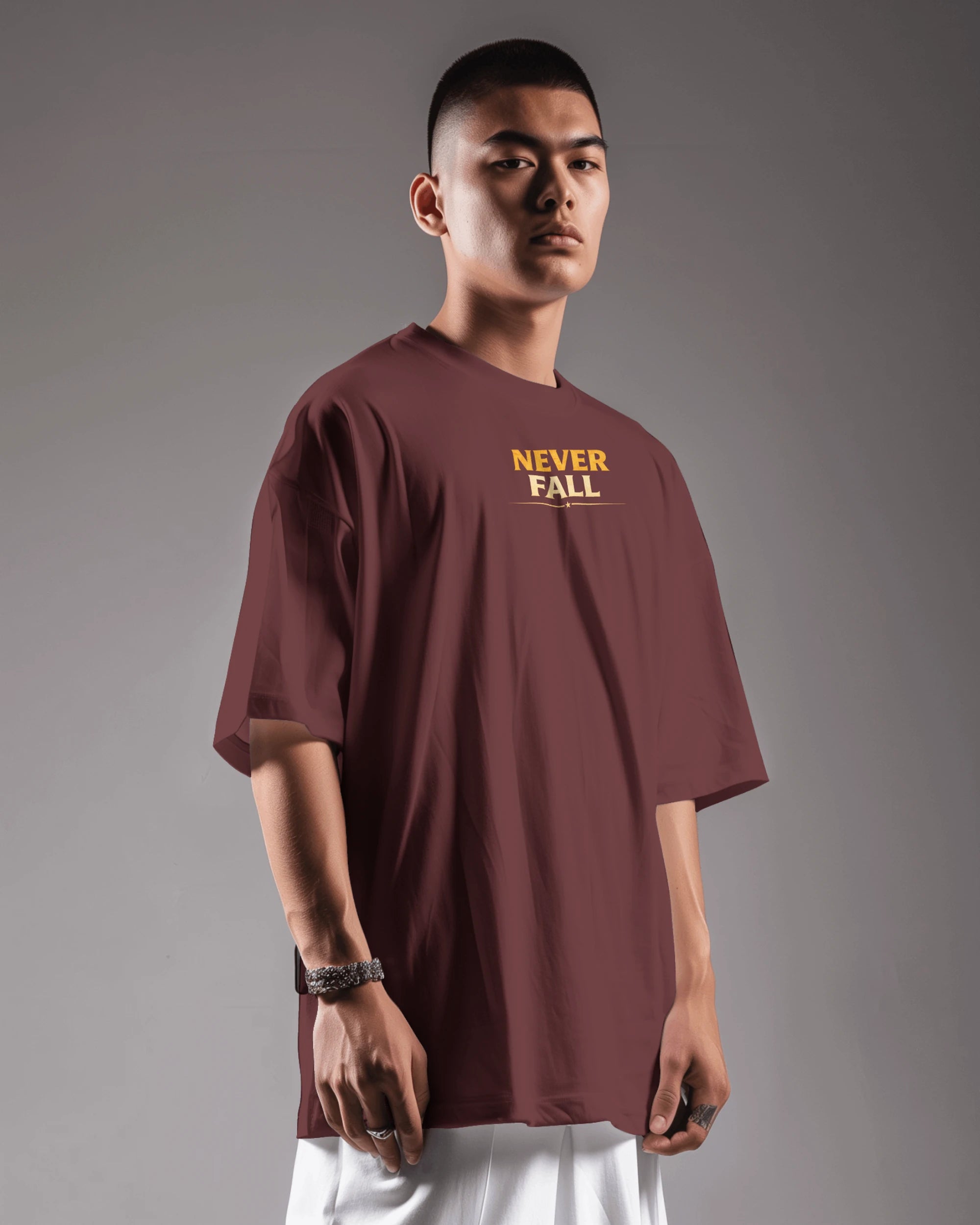 Maroon oversized T-shirt by BhaariGear featuring the Never Fall Warrior Legacy design, front view showing bold graphic and relaxed fit.