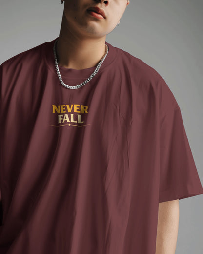 Maroon oversized T-shirt with "Never Fall Warrior Legacy" graphic by BhaariGear, front view showcasing bold design and relaxed fit.
