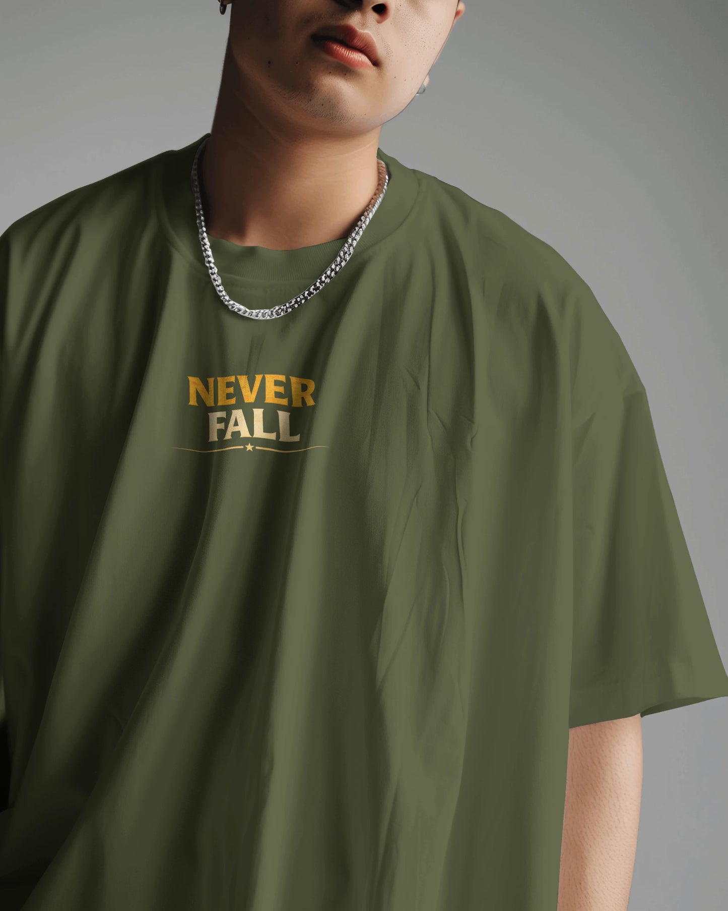 Olive green Never Fall Warrior Legacy oversized T-shirt by BhaariGear, front view showing bold graphic design and relaxed fit.