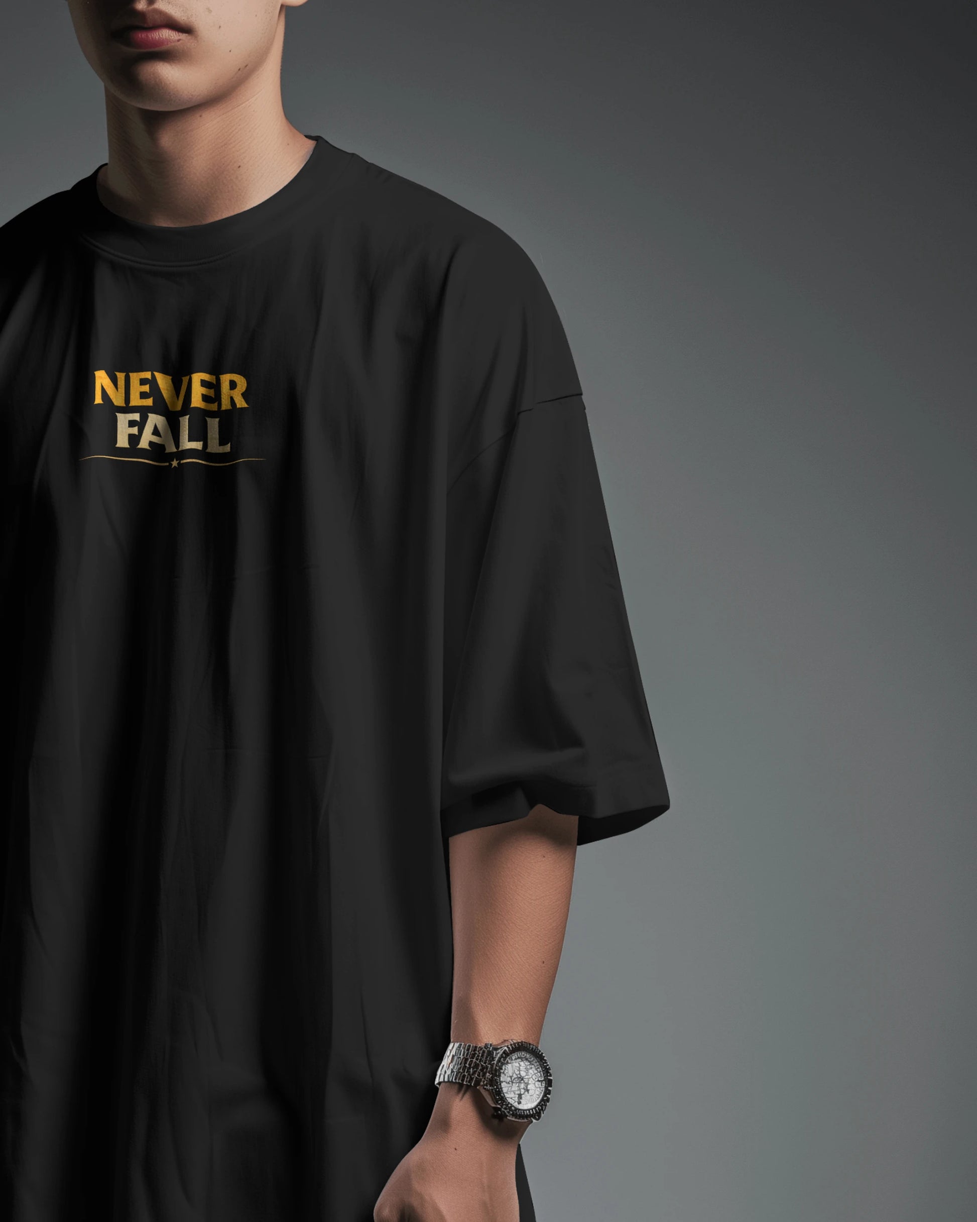 Black oversized T-shirt by BhaariGear with "Never Fall Warrior Legacy" design displayed on the front in a front view.