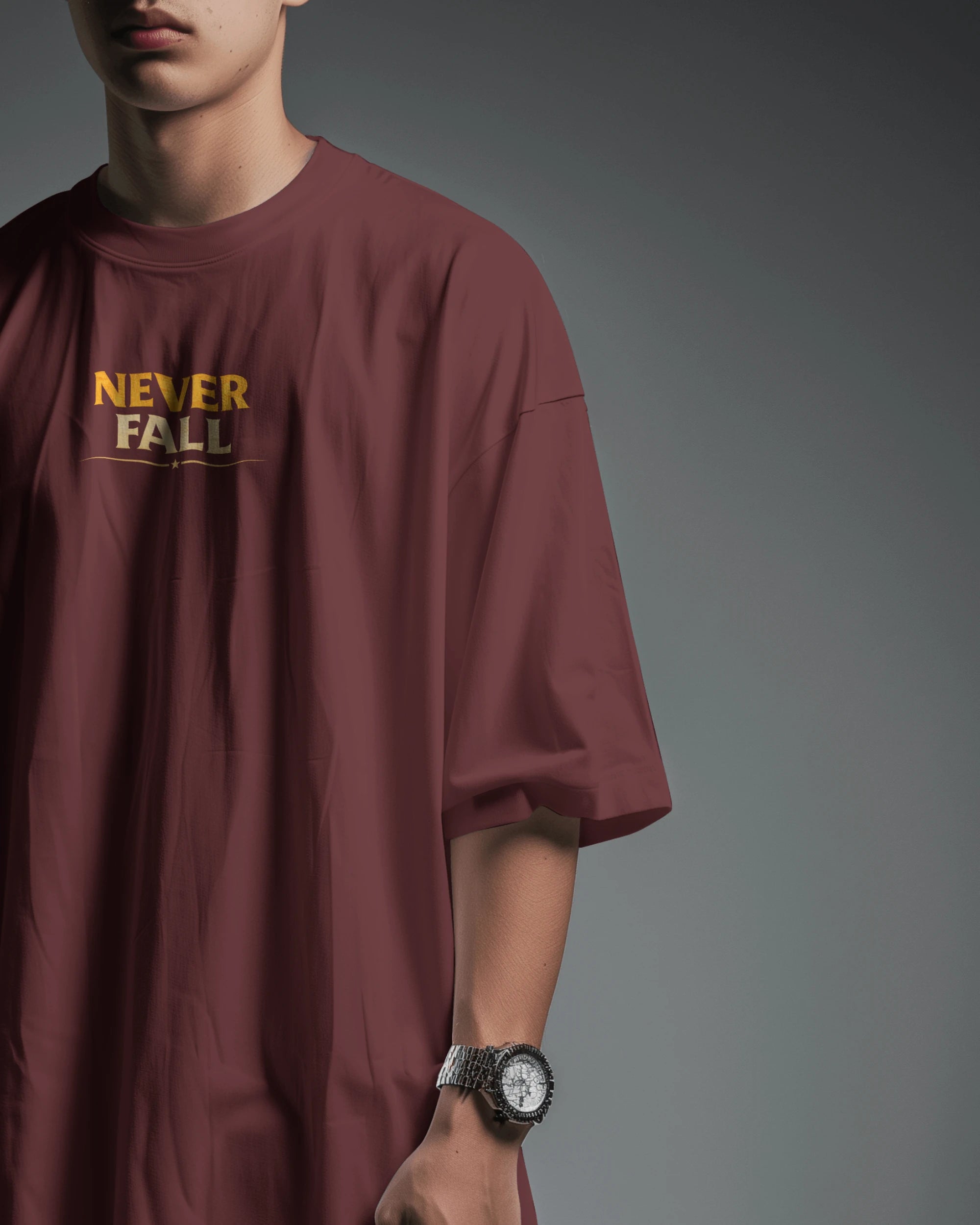 Maroon oversized T-shirt with Never Fall Warrior Legacy design by BhaariGear, front view showing bold graphic print.