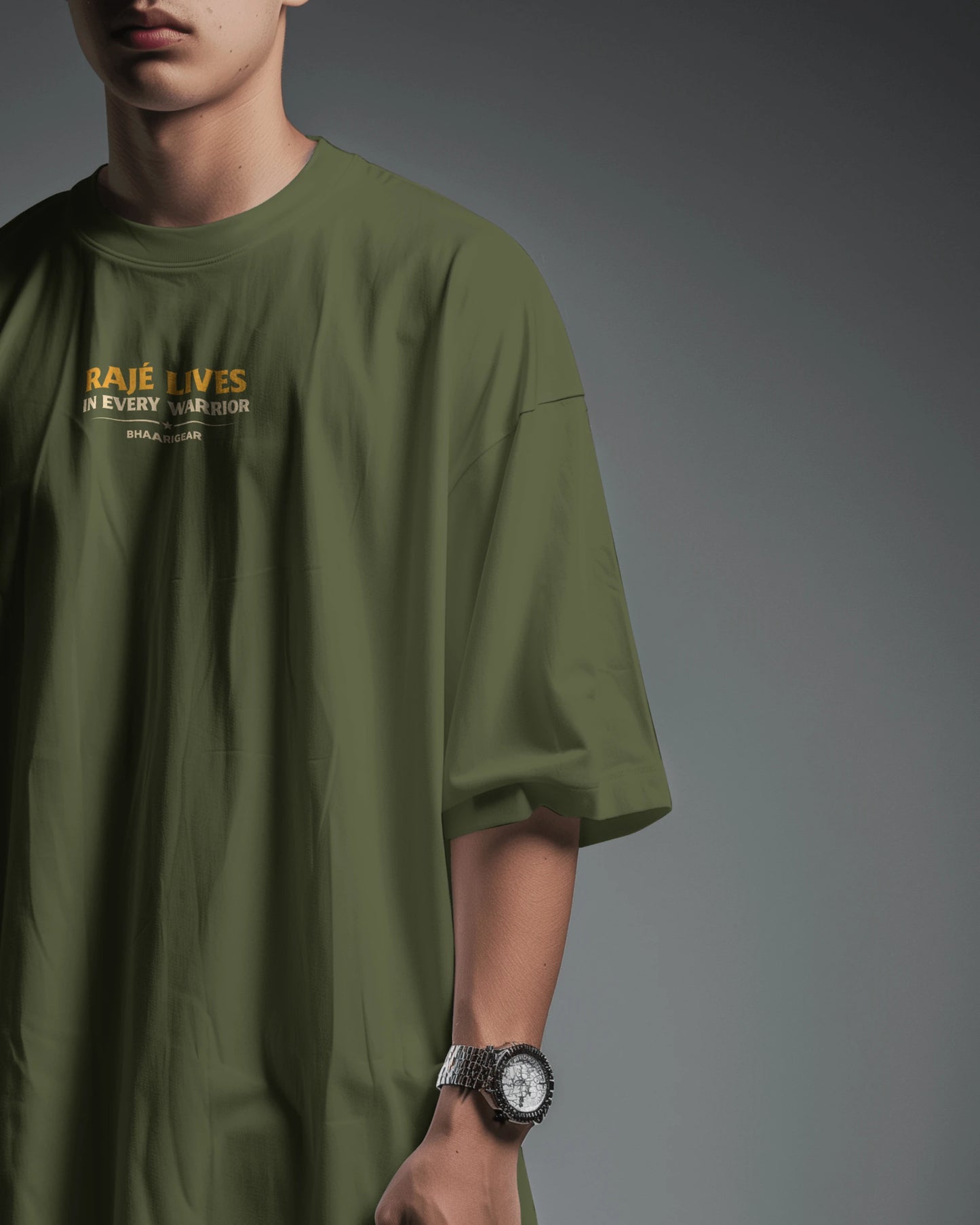 Olive green Raje Lives Warrior oversized graphic T-shirt by BhaariGear, front half-side view showing bold design and relaxed fit.