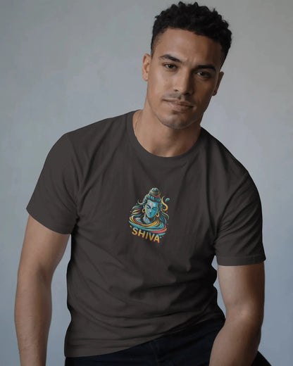 Man wearing a dark coffeebrown t-shirt with a 'Shiva' graphic design on a plain background