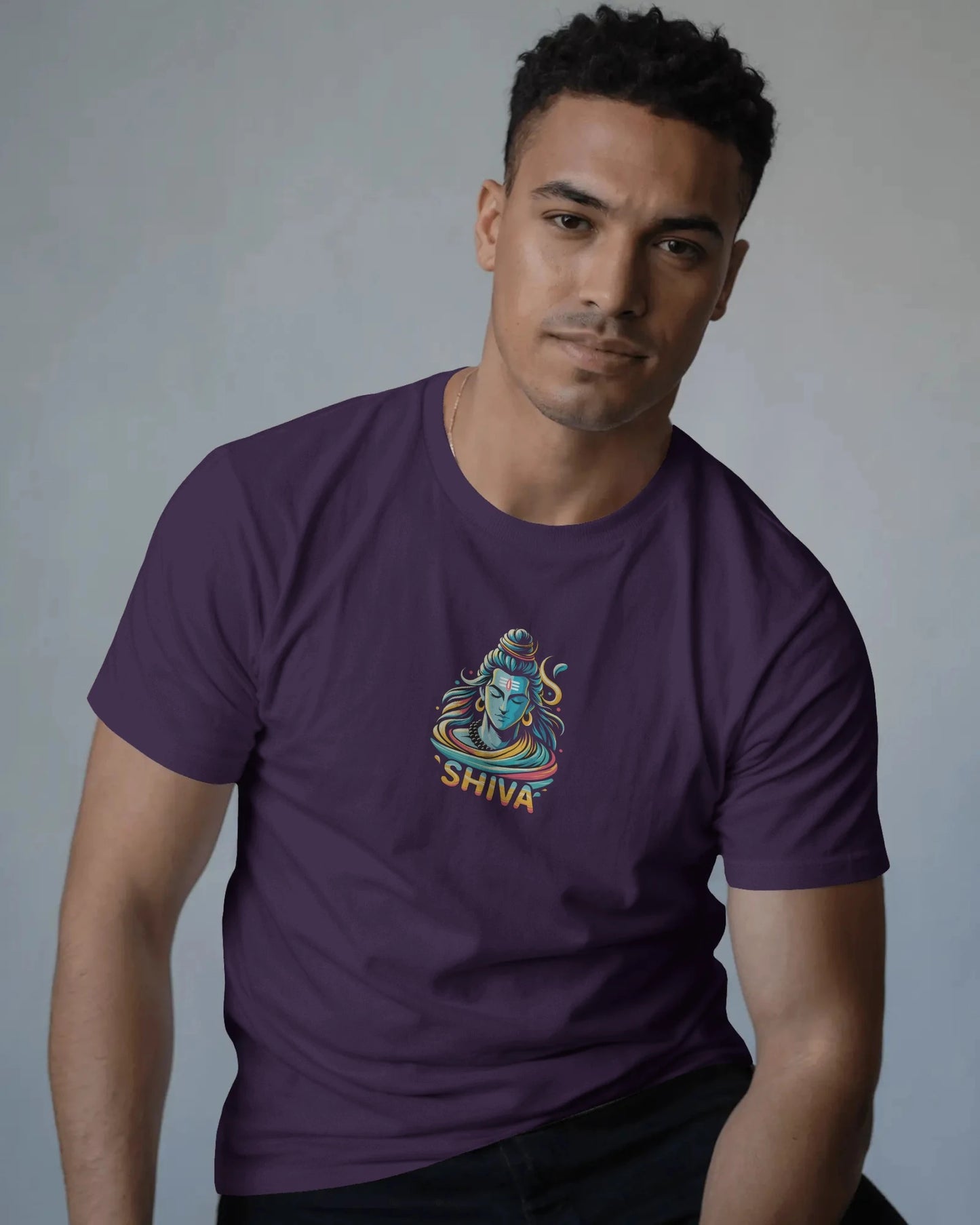 Man wearing a purple t-shirt with a 'Shiva' design on a gray background