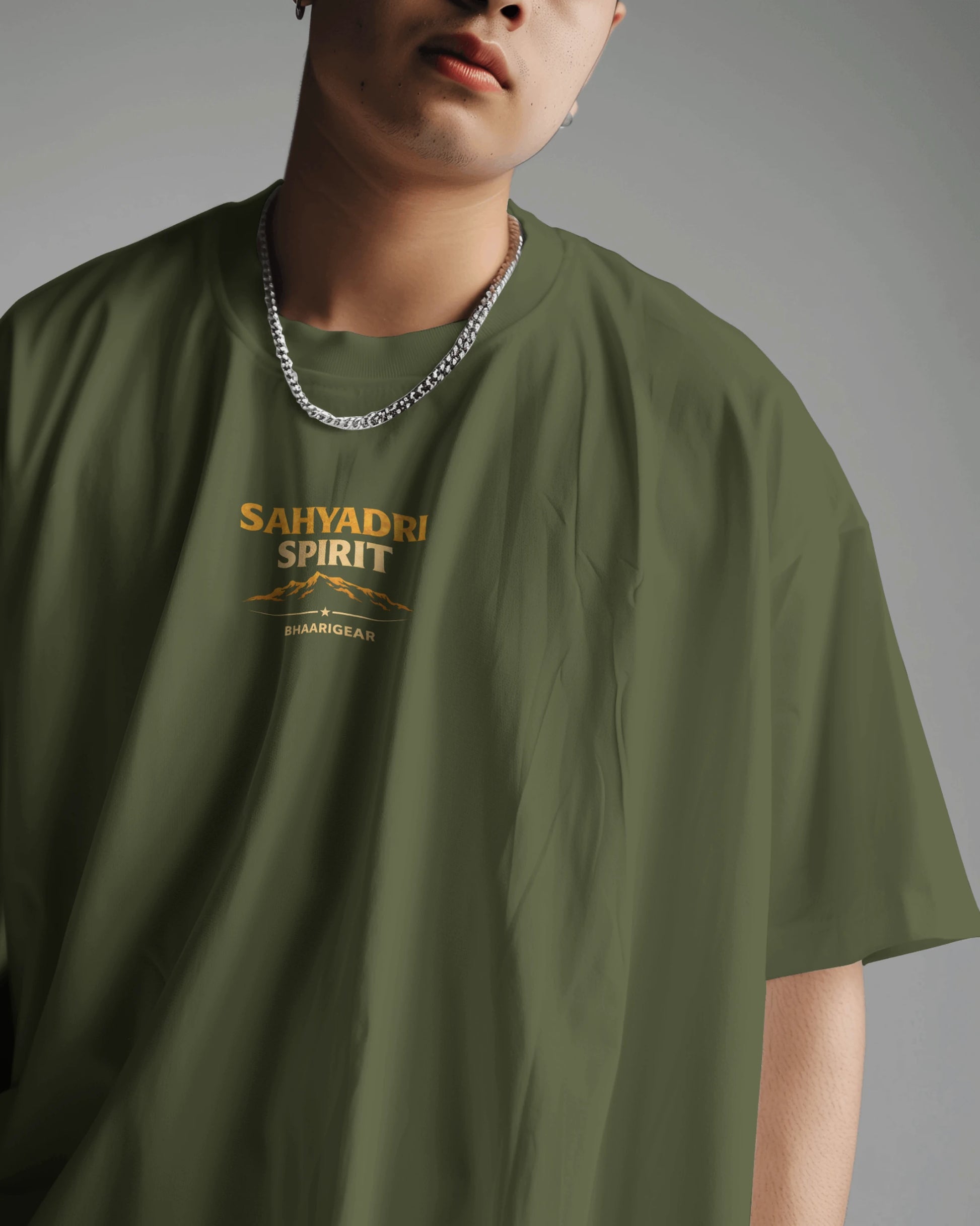 Asian male model wearing BhaariGear Sahyadri Spirit Warrior oversized T-shirt in a casual scene.