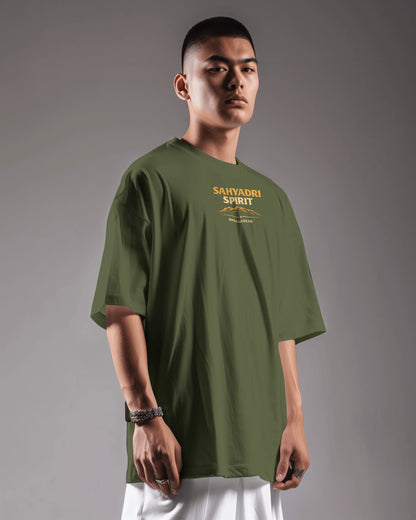 Asian model wearing Sahyadri Spirit Warrior oversized T-shirt by BhaariGear, casual scene, showcasing the relaxed fit and design.
