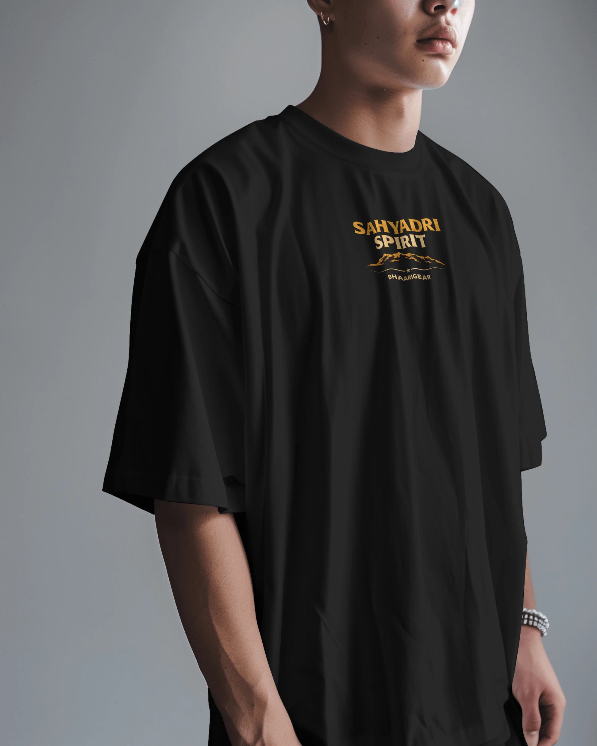 Asian model wearing BhaariGear Sahyadri Spirit Warrior oversized T-shirt showcasing casual streetwear style.