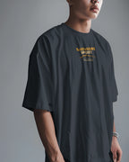 Asian model wearing BhaariGear Sahyadri Spirit Warrior oversized T-shirt, casual fit, front view, in a modern indoor setting.