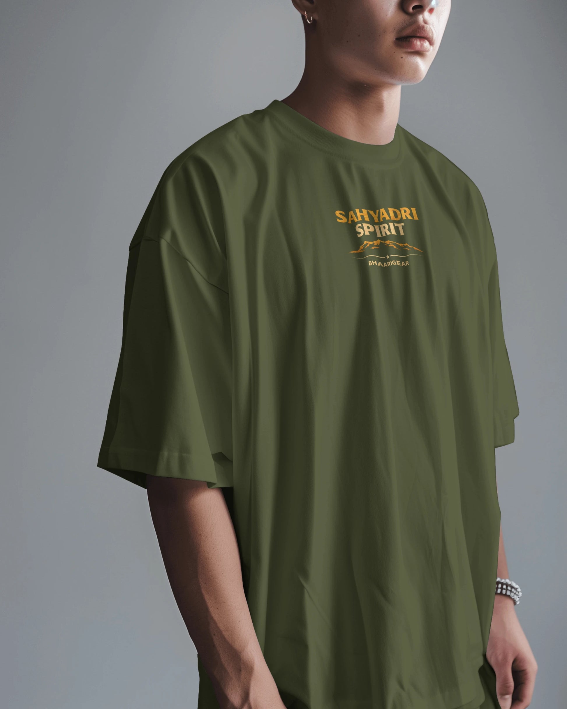 Asian model wearing Sahyadri Spirit Warrior oversized T-shirt by BhaariGear, showcasing relaxed fit and bold graphic design.