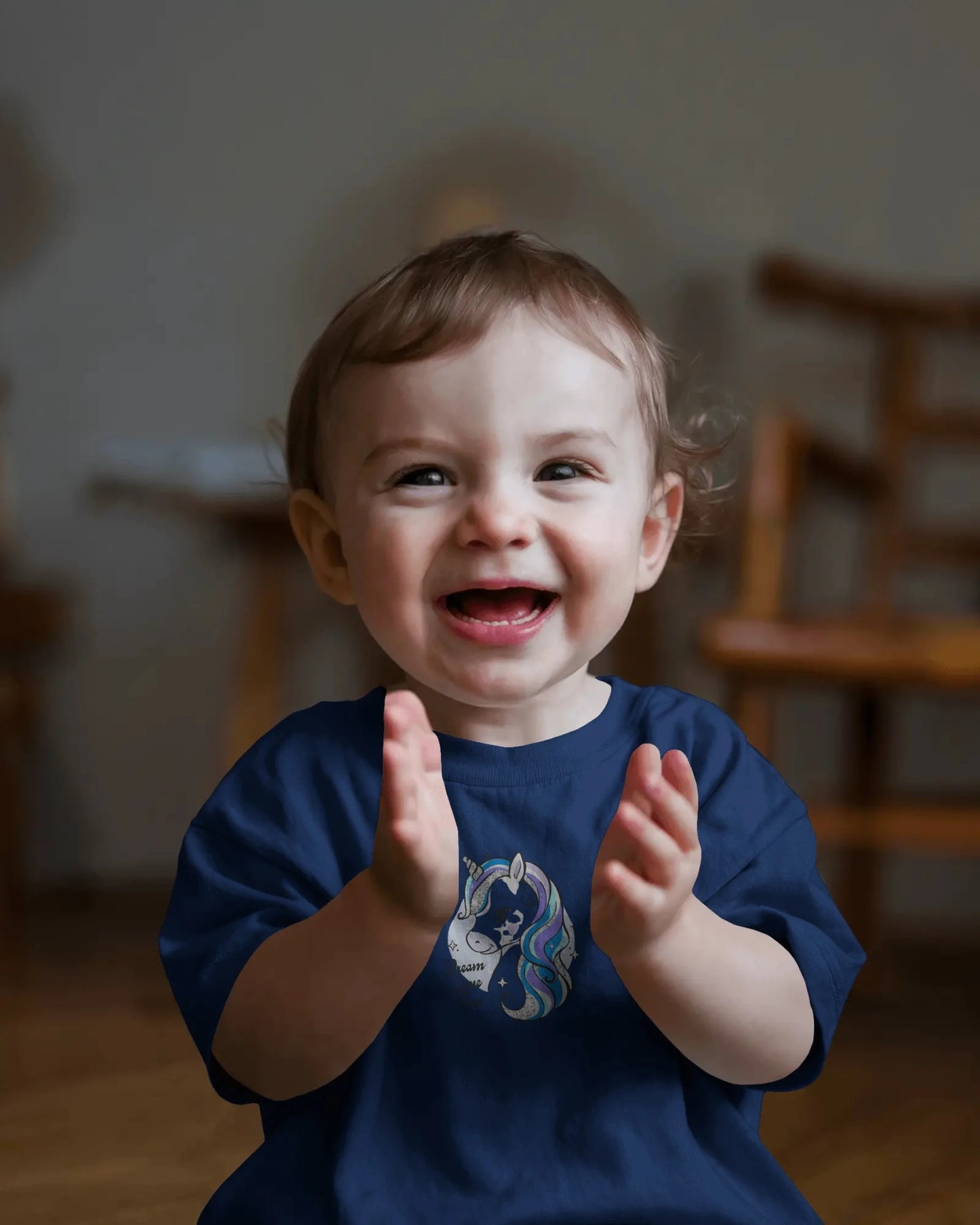 Child clapping hands with a blurred indoor background