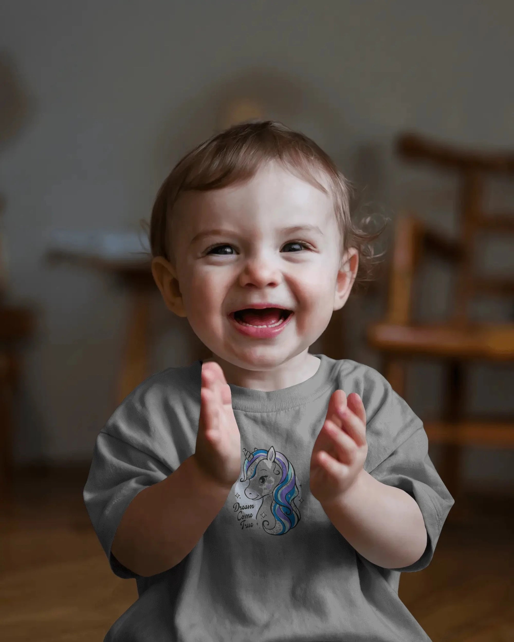 Child clapping hands with a blurred indoor background