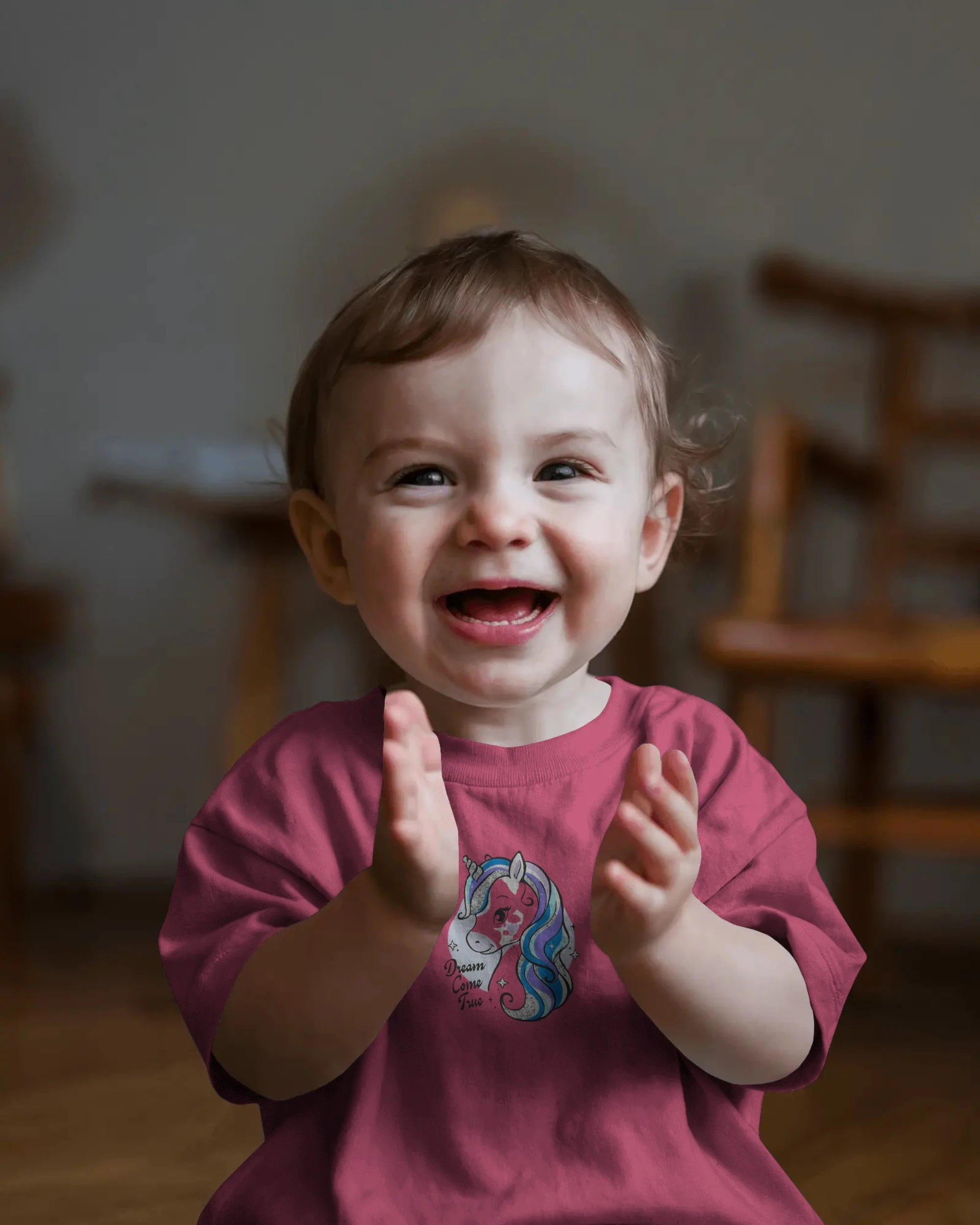 Child clapping hands with a warm indoor setting