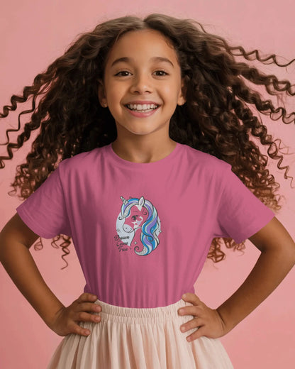 Young girl wearing a pink t-shirt with a unicorn design on a pink background