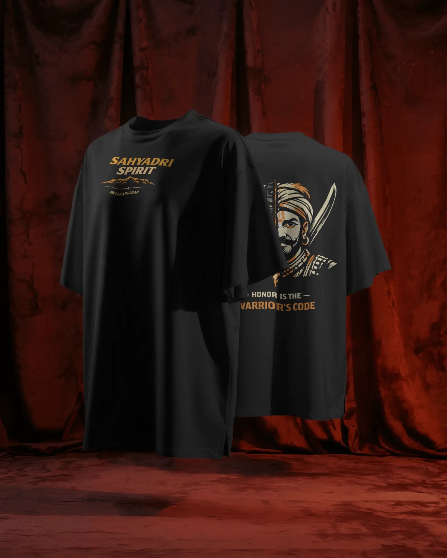 BhaariGear Sahyadri Spirit Warrior oversized T-shirt shown front and back on a floating stand against red curtains.