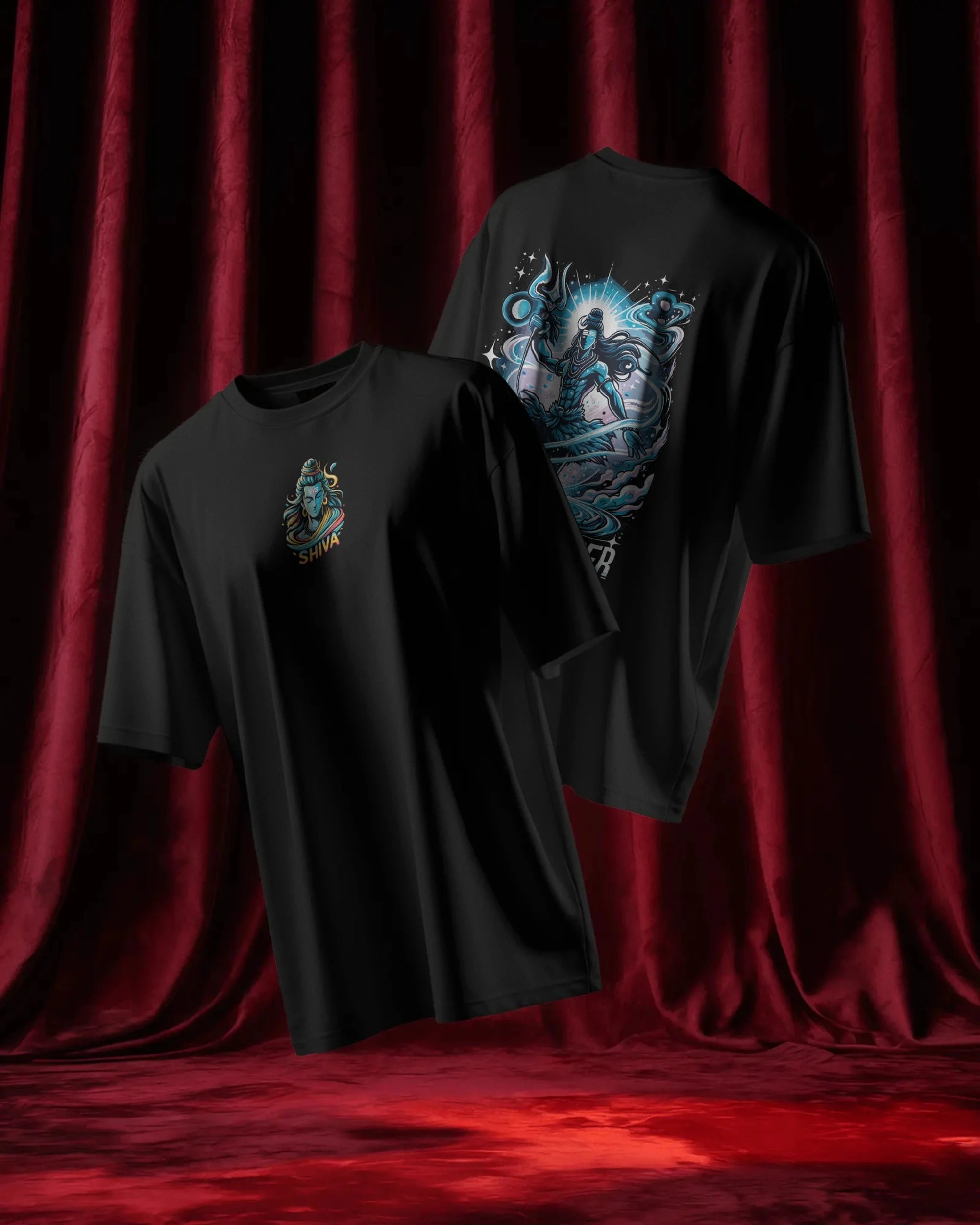Two black t-shirts with graphic designs on a red curtain background