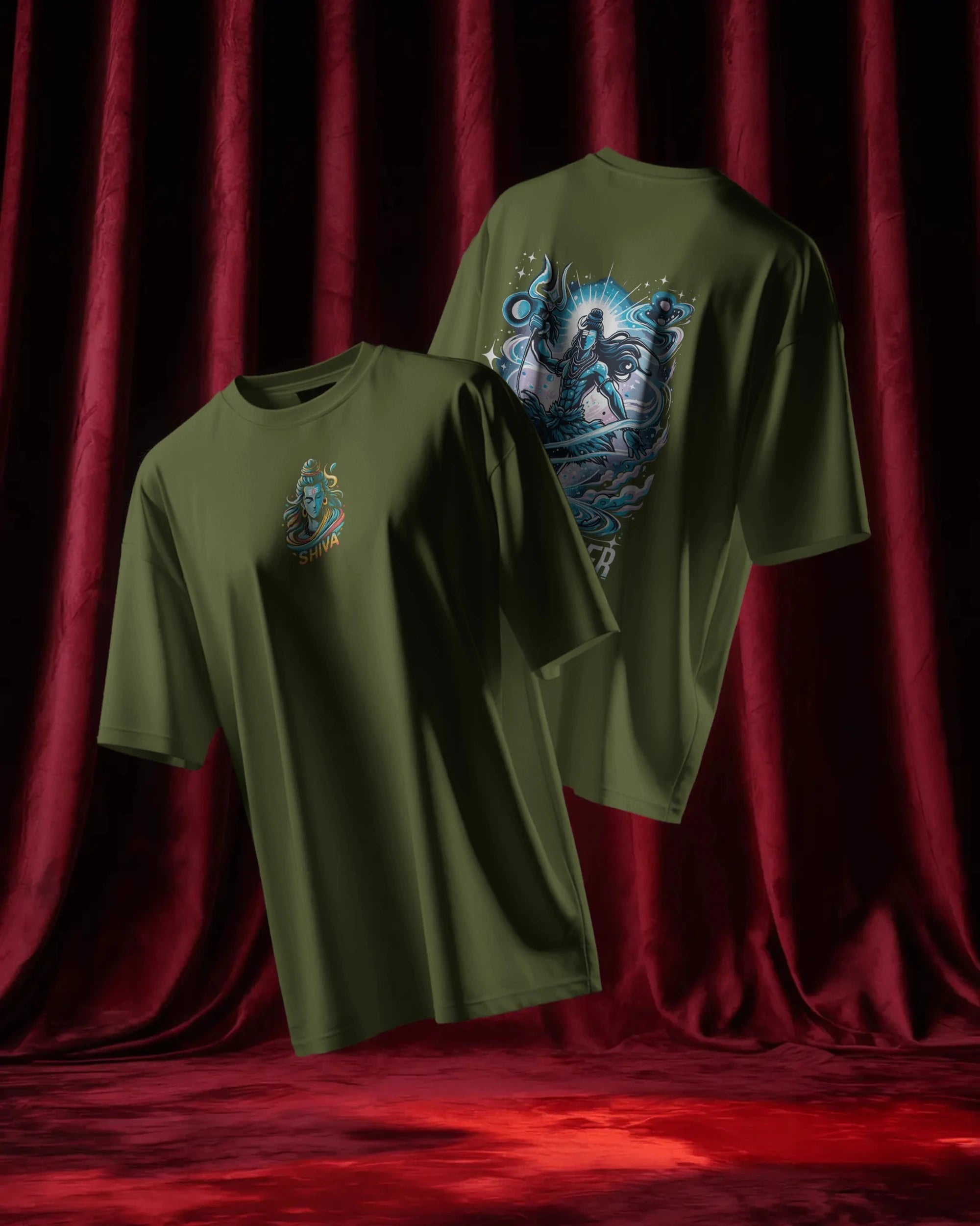Two olive green t-shirts with graphic designs on a red curtain background