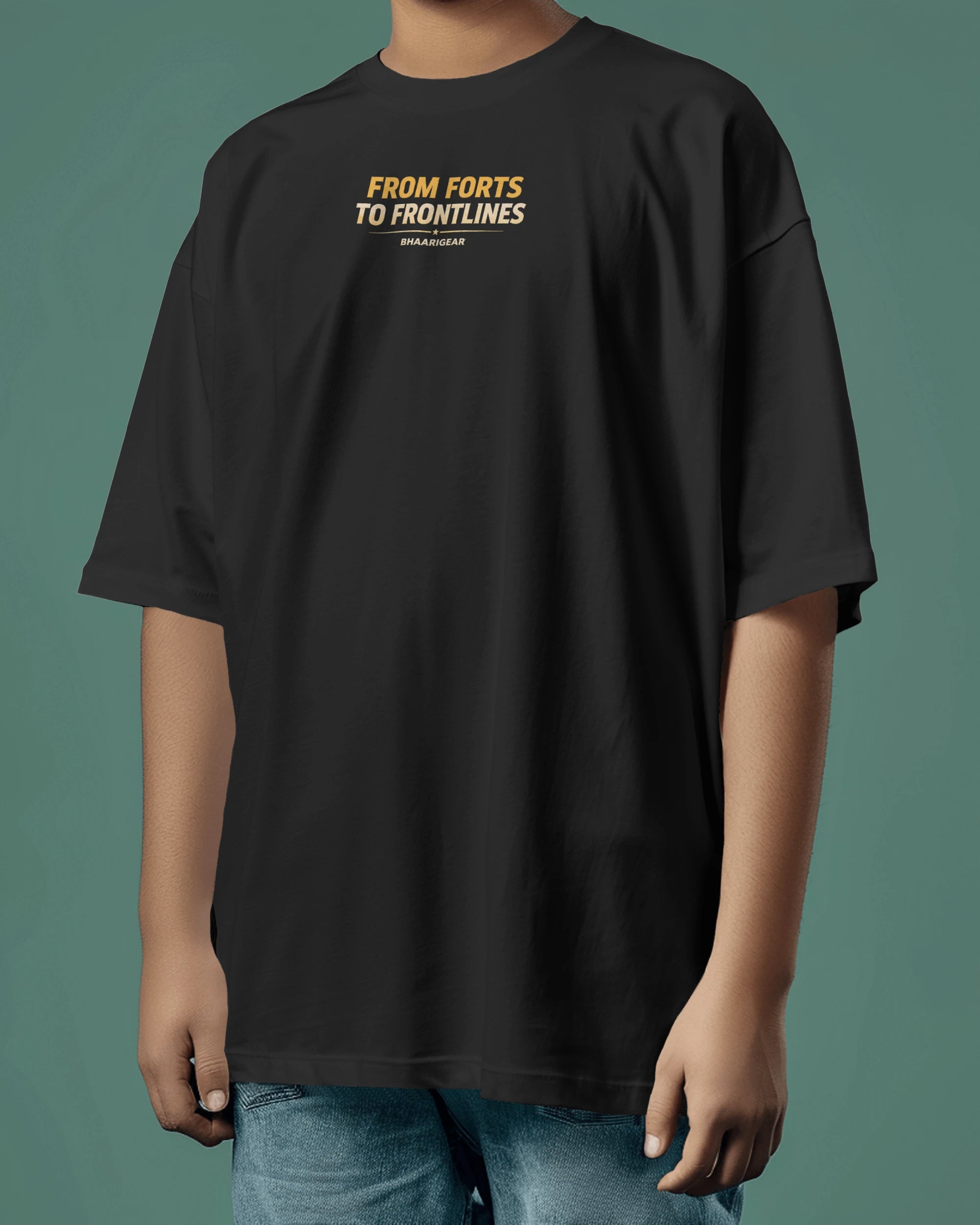 Person wearing a black Oversize t-shirt with text on a green background