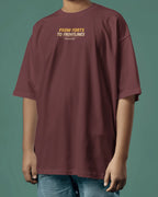 Maroon t-shirt with text 'From Forts to Frontlines' worn by a person on a green background