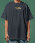 Person wearing a navy blue t-shirt with text on a green background