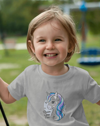 Child wearing a t-shirt with a unicorn design outdoors