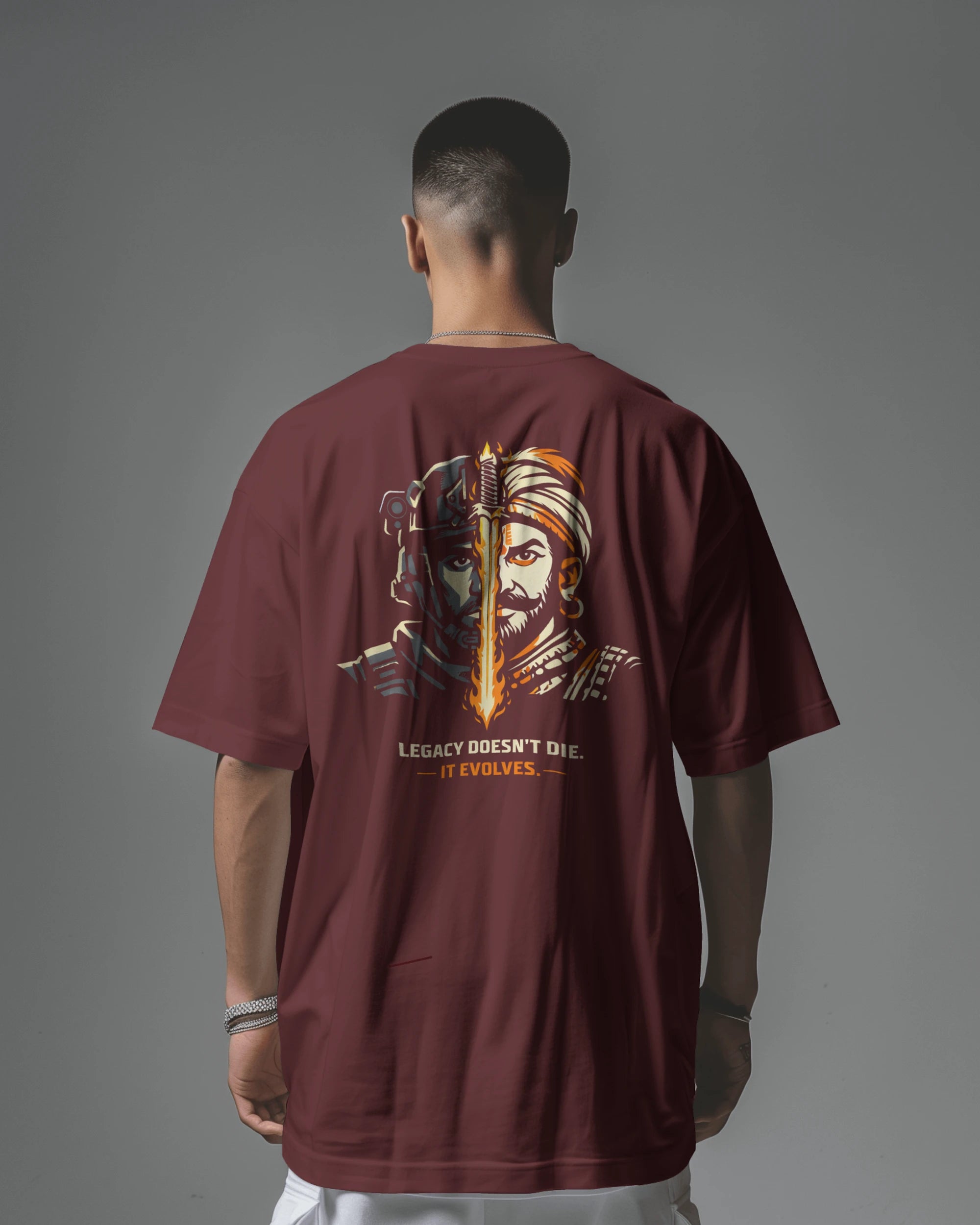 Man wearing a maroon t-shirt with a graphic design on the back against a gray background