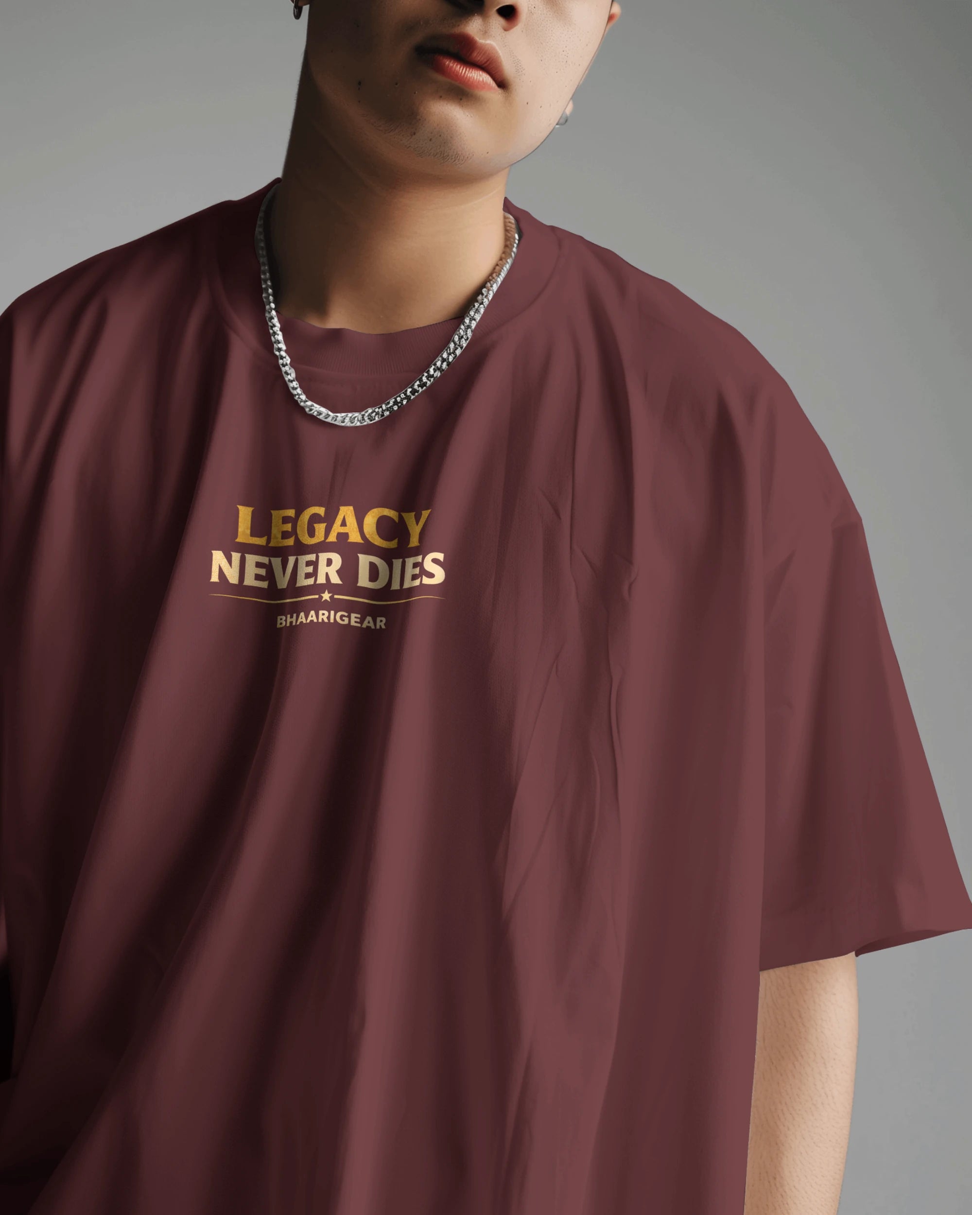 Person wearing a maroon t-shirt with 'Legacy Never Dies' text on a gray background