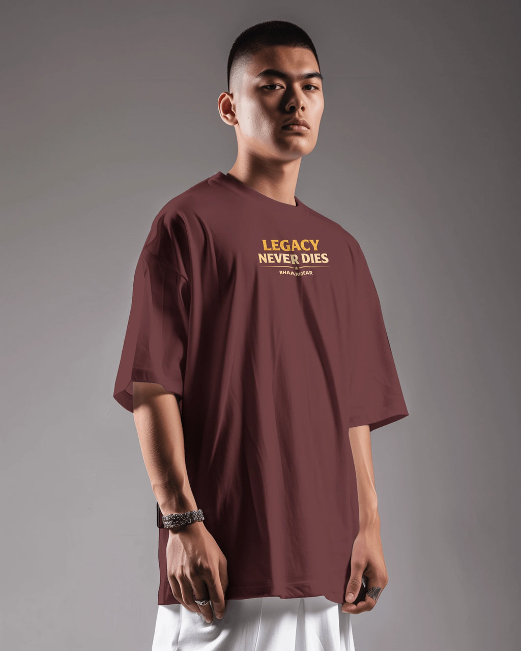 Man wearing a maroon t-shirt with 'Legacy Never Dies' text on a gray background