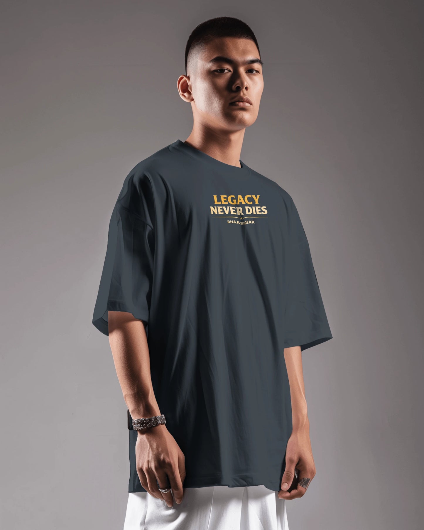 Person wearing a dark navy blue t-shirt with 'Legacy Never Dies' text on a gray background