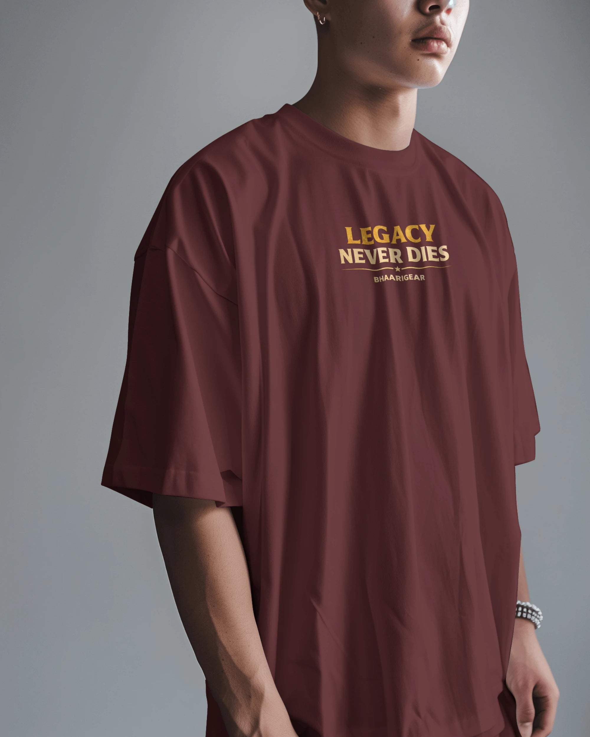 Person wearing a maroon t-shirt with 'Legacy Never Dies' text on a gray background