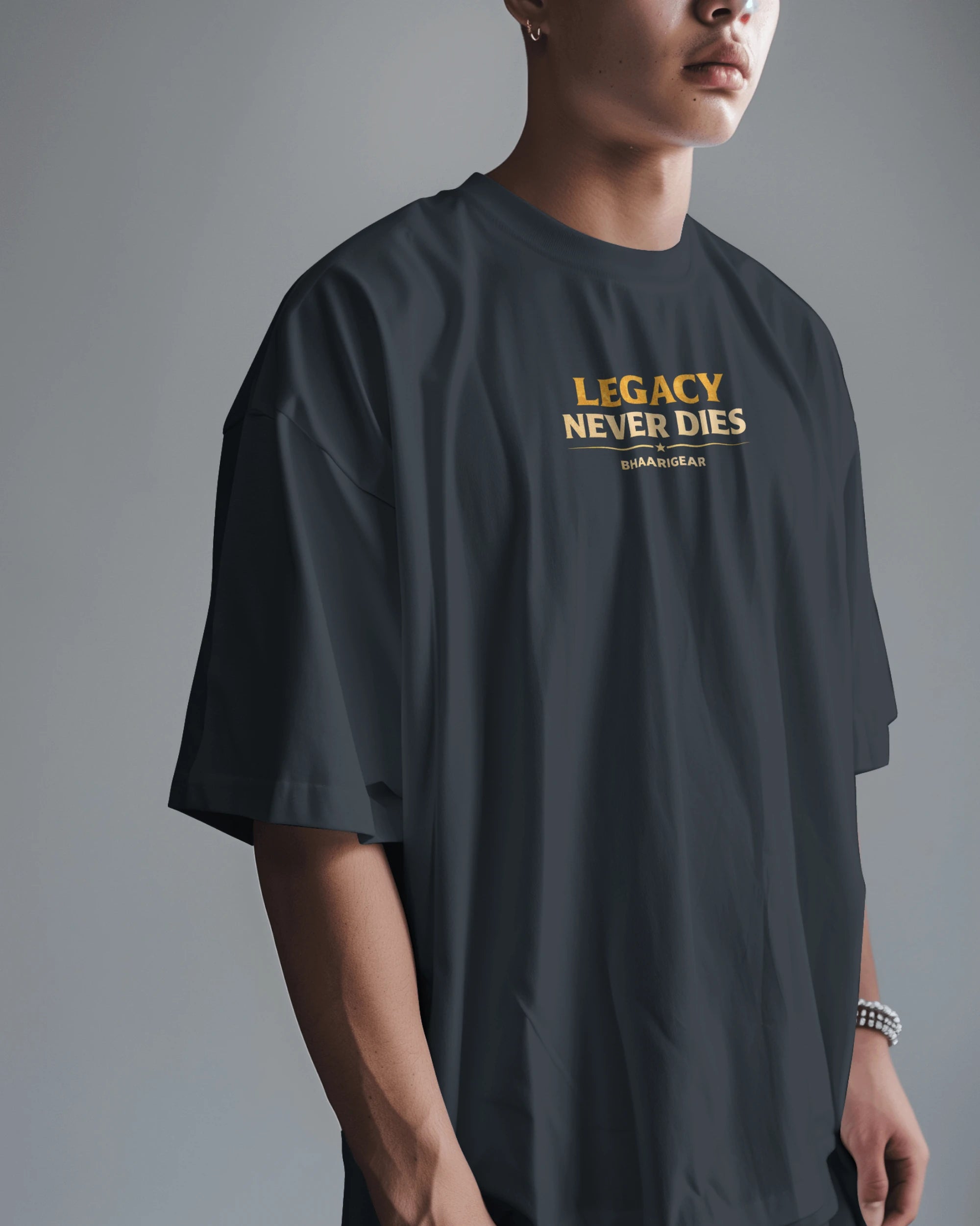 Person wearing a dark navy blue t-shirt with 'Legacy Never Dies' text on a gray background