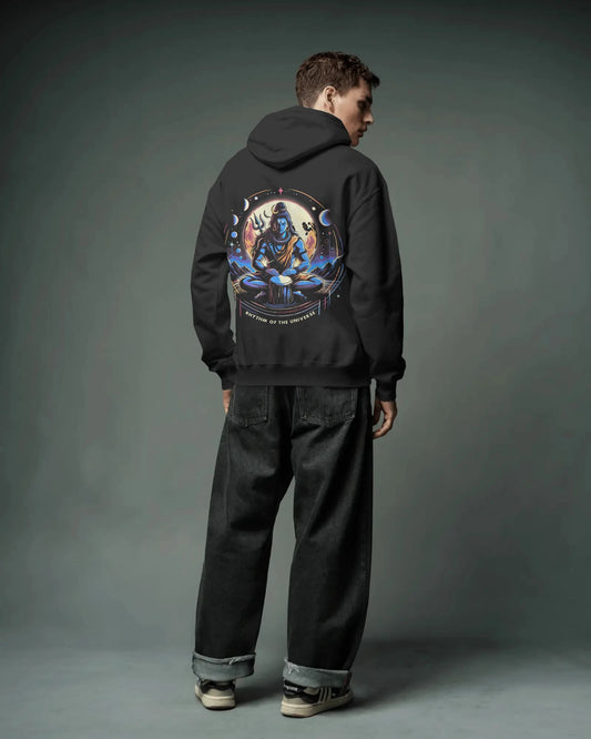 Person wearing a black hoodie with a colorful graphic on the back against a gray background