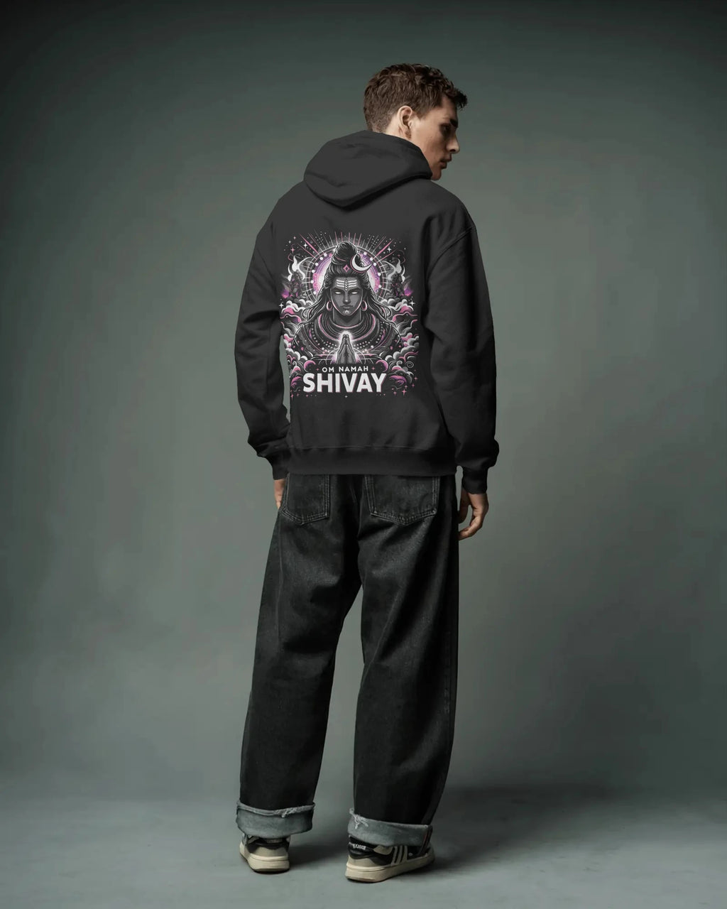 Person wearing a black pulloverhoodie with 'Shivay' design on the back against a gray background