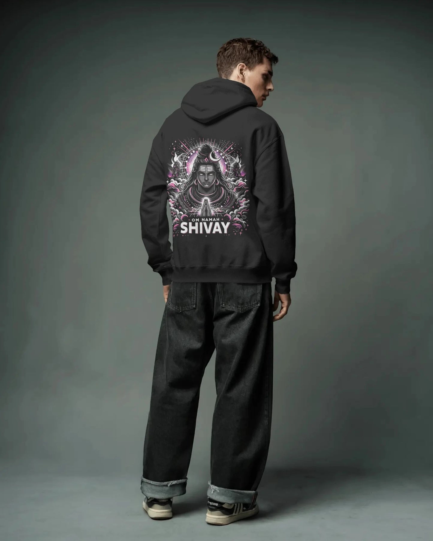 Person wearing a black pulloverhoodie with 'Shivay' design on the back against a gray background