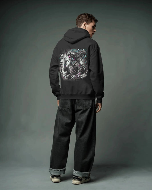 Person wearing a black Pullover hoodie with a graphic design on the back against a gray background